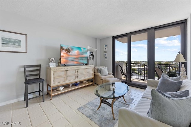 180 Seaview Ct Unit 814, Marco Island, FL 34145 - living room featuring a textured ceiling, baseboards, and light tile patterned flooring