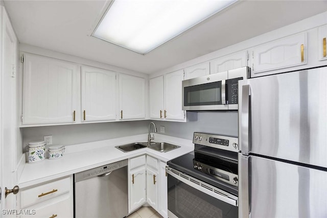 180 Seaview Ct Unit 814, Marco Island, FL 34145 - kitchen with a sink, white cabinets, light countertops, appliances with stainless steel finishes, and light tile patterned flooring