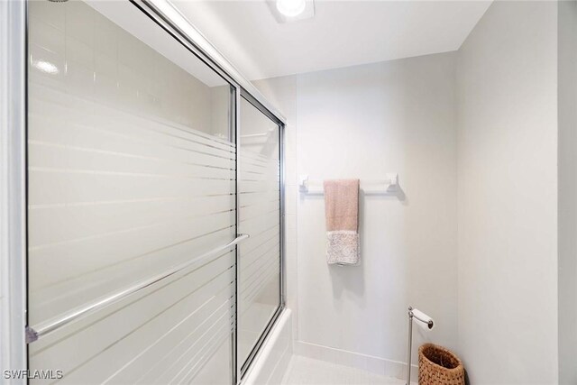180 Seaview Ct Unit 814, Marco Island, FL 34145 - bathroom featuring baseboards and enclosed tub / shower combo