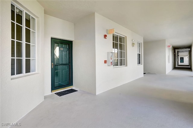 doorway to property with stucco siding