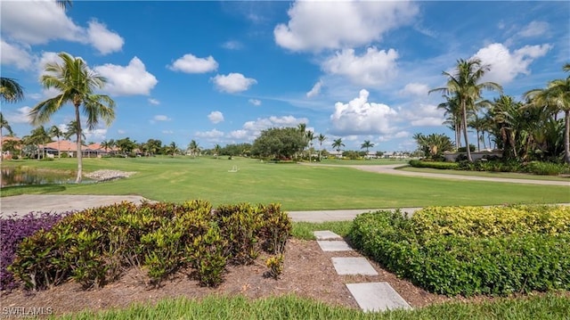 view of community with a yard and golf course view