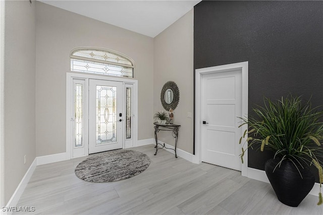 1255 Eider Ct, Punta Gorda, FL 33950 - entryway featuring a towering ceiling, light wood-type flooring, and baseboards