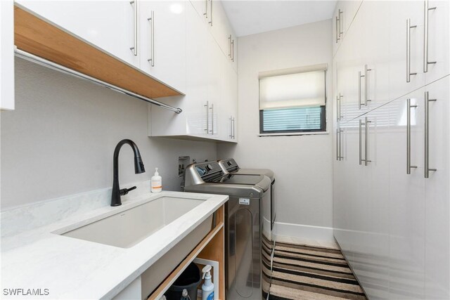 1255 Eider Ct, Punta Gorda, FL 33950 - laundry area with cabinet space, washer and dryer, and baseboards