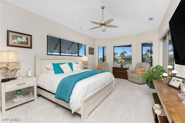 1255 Eider Ct, Punta Gorda, FL 33950 - bedroom with multiple windows, light carpet, vaulted ceiling, and a ceiling fan