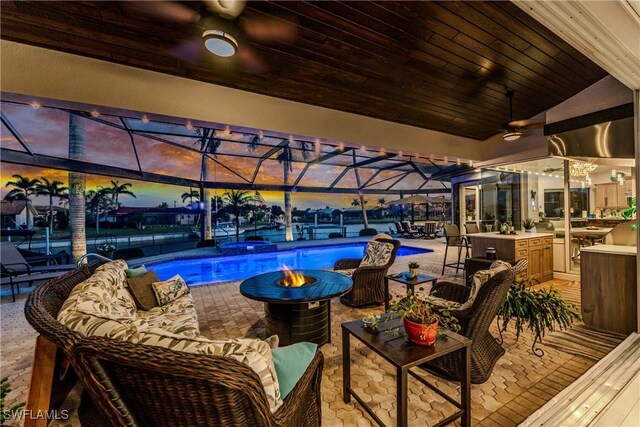 1255 Eider Ct, Punta Gorda, FL 33950 - swimming pool featuring ceiling fan, a patio, a lanai, and an outdoor living space with a fire pit