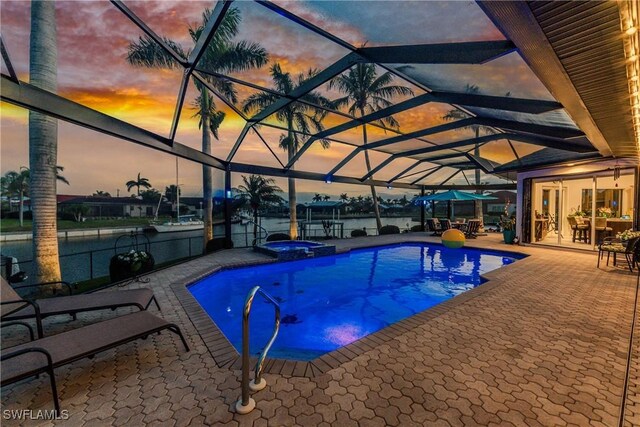1255 Eider Ct, Punta Gorda, FL 33950 - view of pool featuring a patio area, a pool with connected hot tub, a lanai, and a water view