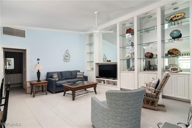 4752 Maupiti Way, Naples, FL 34119 - living area featuring light tile patterned floors, crown molding, and built in shelves