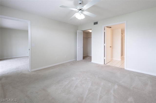 unfurnished bedroom featuring carpet flooring, baseboards, a ceiling fan, and a closet