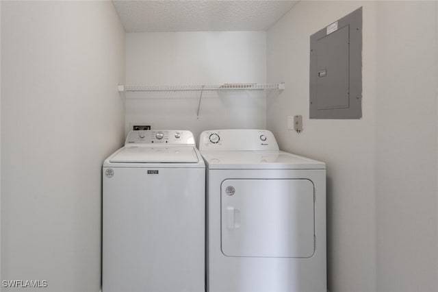 laundry area with electric panel and independent washer and dryer
