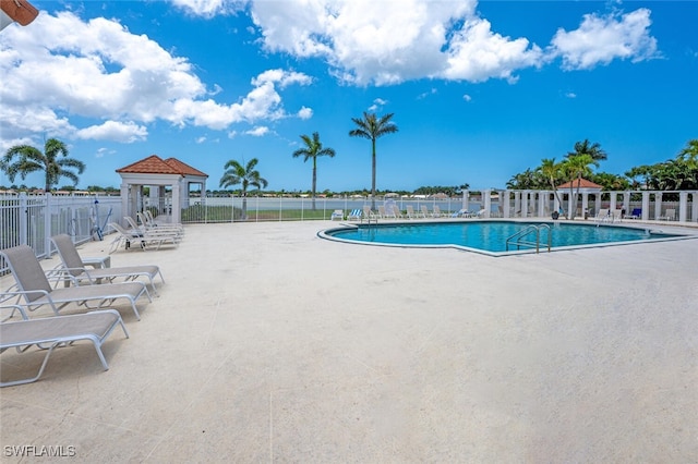 community pool featuring a patio, fence, and a gazebo