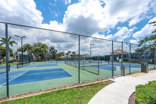 view of tennis court featuring fence