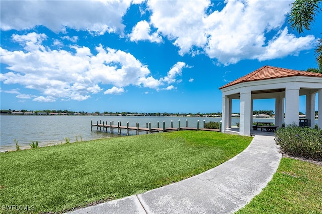 dock area with a yard, a gazebo, and a water view