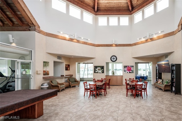 dining space with wooden ceiling, a towering ceiling, and billiards table