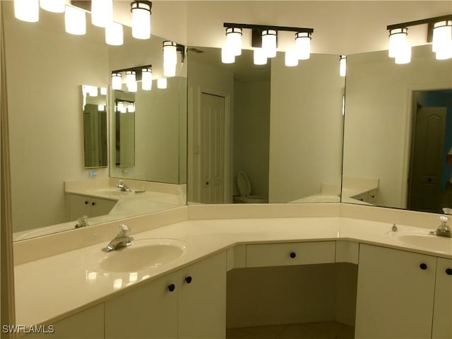 full bathroom with double vanity, a sink, and tile patterned flooring