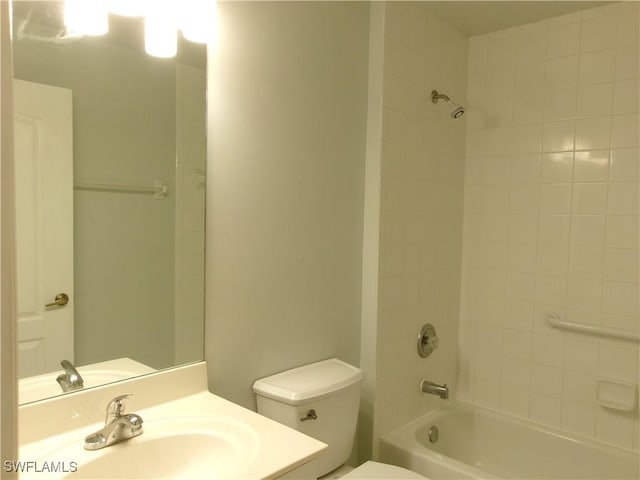 bathroom with toilet, bathing tub / shower combination, and vanity