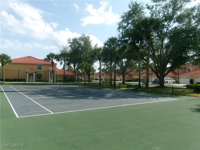 view of sport court featuring fence