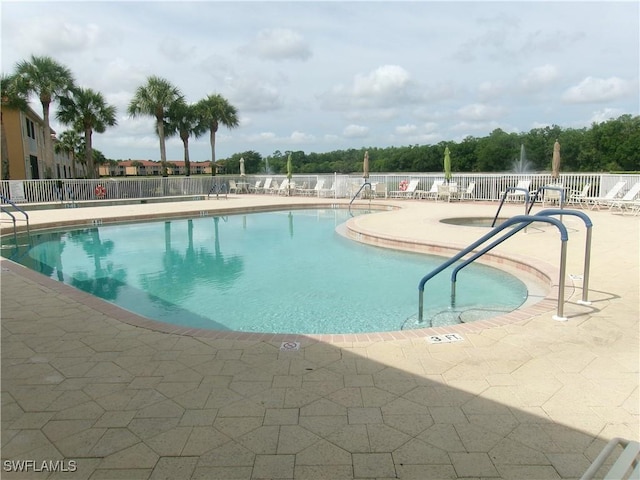 community pool featuring a patio area and fence