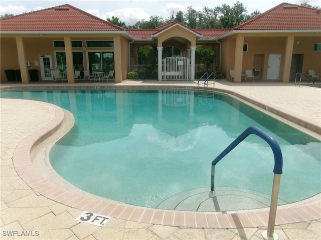 community pool featuring a patio area