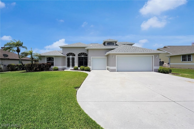 view of front of home with an attached garage, driveway, stucco siding, a front lawn, and a shingled roof