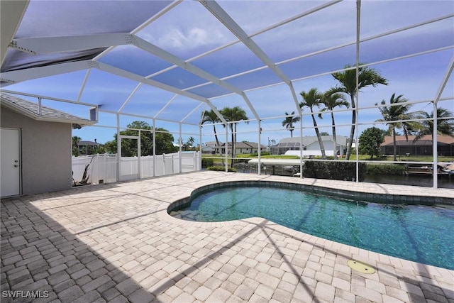 pool featuring a patio area and glass enclosure