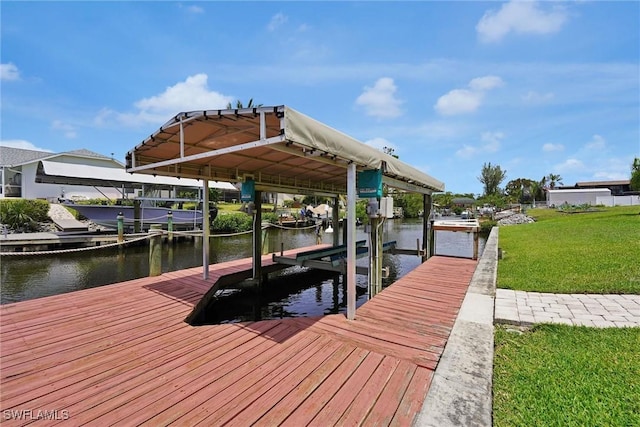 view of dock featuring a water view, a yard, and boat lift