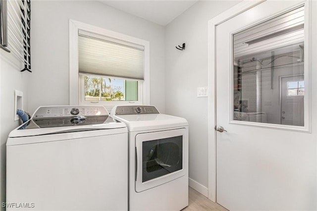 420 Donora Blvd, Fort Myers Beach, FL 33931 - laundry room with washer and clothes dryer, light wood-style flooring, and baseboards