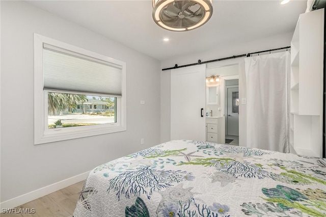 420 Donora Blvd, Fort Myers Beach, FL 33931 - bedroom with wood finished floors, a barn door, baseboards, and recessed lighting