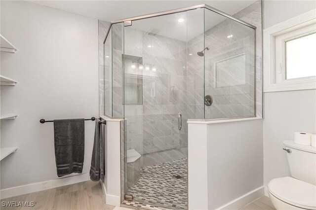 420 Donora Blvd, Fort Myers Beach, FL 33931 - full bathroom featuring toilet, baseboards, wood finished floors, and a stall shower