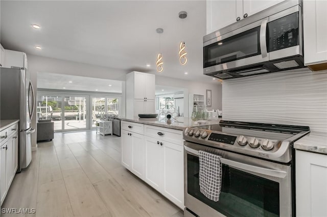 420 Donora Blvd, Fort Myers Beach, FL 33931 - kitchen with appliances with stainless steel finishes, white cabinetry, light stone counters, and recessed lighting