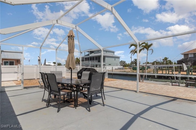 420 Donora Blvd, Fort Myers Beach, FL 33931 - view of patio featuring glass enclosure, outdoor dining area, a water view, and fence