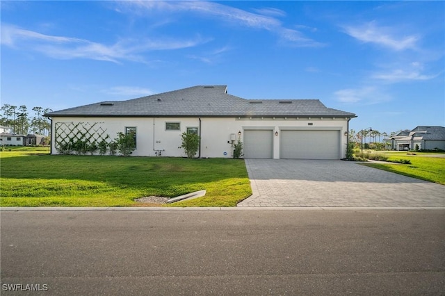 19570 Panther Island Blvd, Estero, FL 33928 - view of front of property featuring an attached garage, decorative driveway, a front yard, and stucco siding