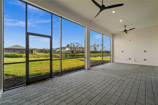 19570 Panther Island Blvd, Estero, FL 33928 - unfurnished sunroom featuring a ceiling fan and a water view