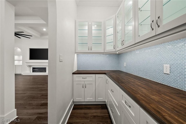 19570 Panther Island Blvd, Estero, FL 33928 - bar featuring dark wood-style flooring, decorative backsplash, ornamental molding, beam ceiling, and a fireplace