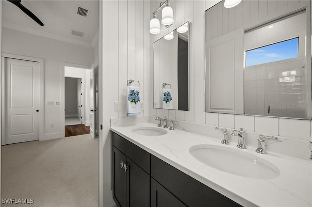 19570 Panther Island Blvd, Estero, FL 33928 - bathroom featuring ornamental molding, double vanity, tiled shower, and ceiling fan