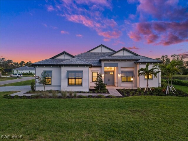 19570 Panther Island Blvd, Estero, FL 33928 - back of property at dusk with a yard