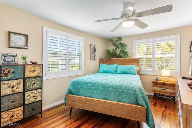 bedroom with ceiling fan, baseboards, and wood finished floors