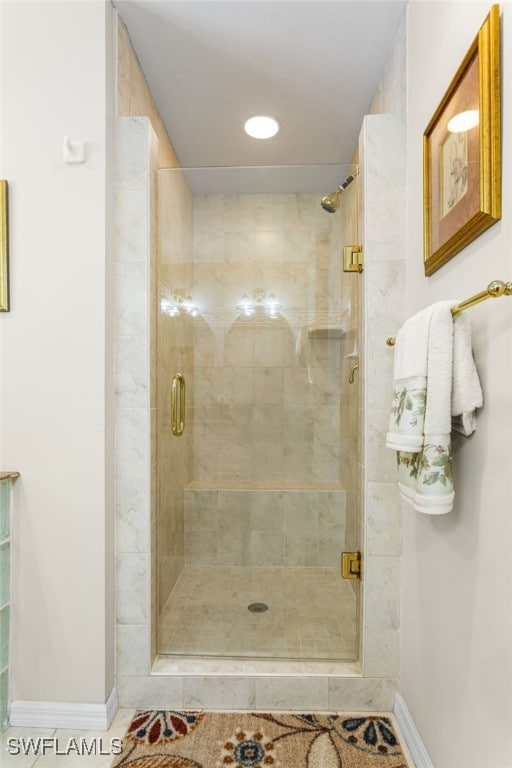 full bath with baseboards, a shower stall, and recessed lighting