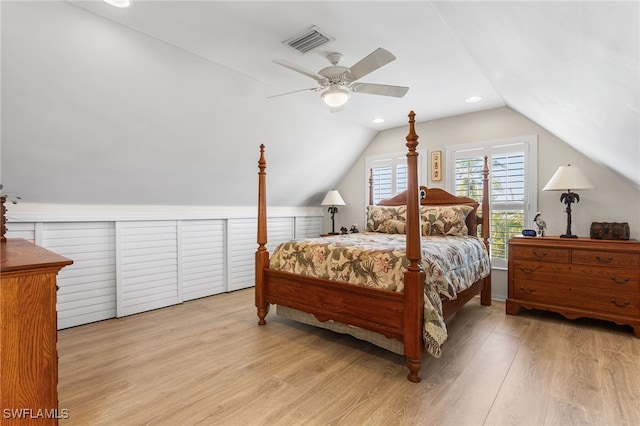 bedroom with lofted ceiling, visible vents, a ceiling fan, and wood finished floors