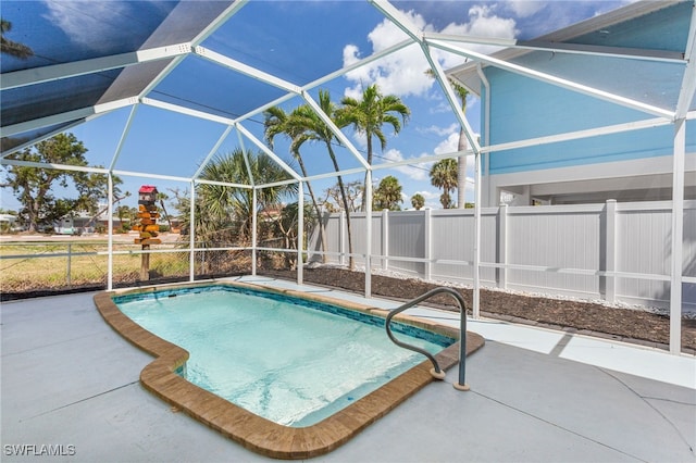 view of pool featuring a patio, a lanai, fence, and a fenced in pool