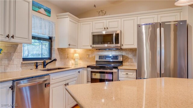 1017 SW 37th Ln, Cape Coral, FL 33914 - kitchen with white cabinets, backsplash, appliances with stainless steel finishes, and a sink