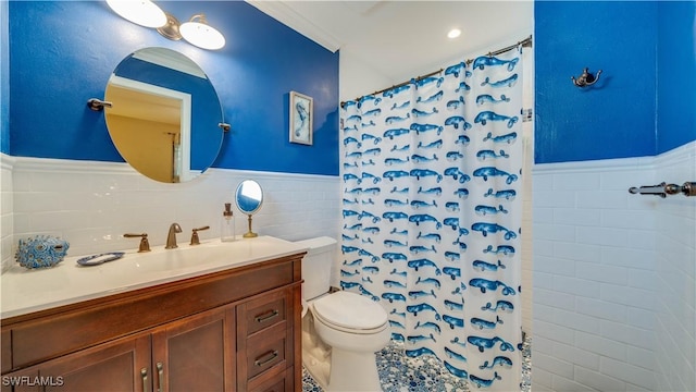 1017 SW 37th Ln, Cape Coral, FL 33914 - bathroom with tile walls, toilet, vanity, curtained shower, and wainscoting