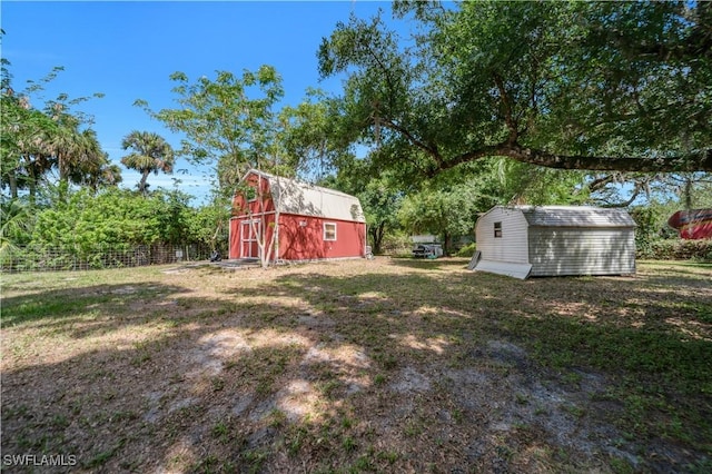 18511 Slater Rd, North Fort Myers, FL 33917 - view of yard featuring an outbuilding, a barn, a storage shed, and fence