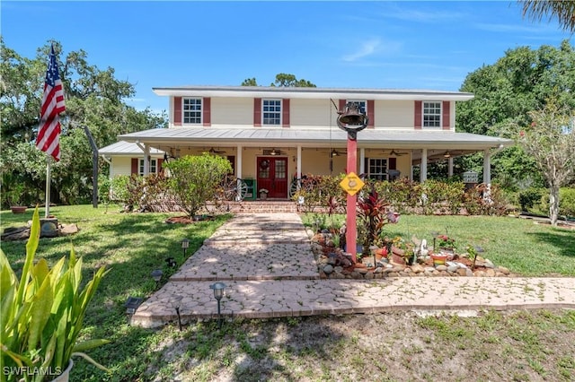 18511 Slater Rd, North Fort Myers, FL 33917 - view of front of house featuring a ceiling fan, a front lawn, and a porch
