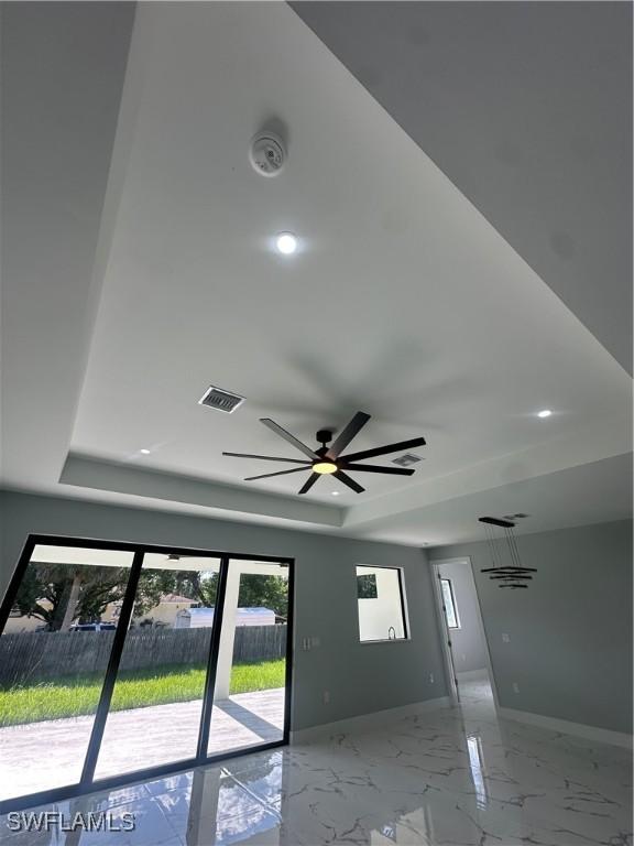 178 Mcarthur Blvd, Lehigh Acres, FL 33974 - detailed view of a raised ceiling, a ceiling fan, and a smoke detector