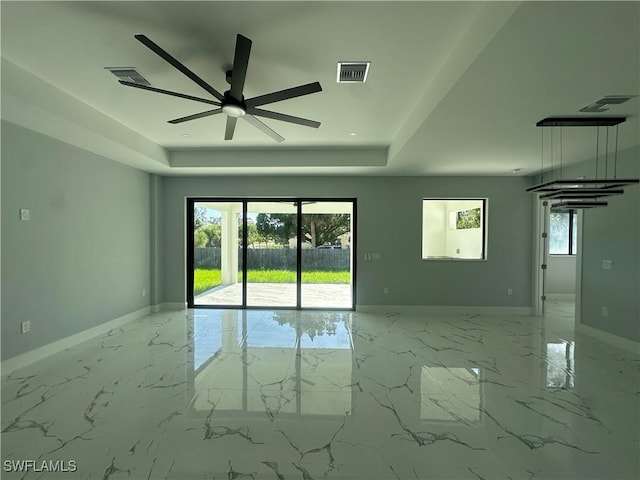 178 Mcarthur Blvd, Lehigh Acres, FL 33974 - spare room with a raised ceiling, a ceiling fan, and marble finish floors