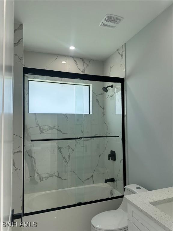 178 Mcarthur Blvd, Lehigh Acres, FL 33974 - full bath with plenty of natural light, vanity, and bath / shower combo with glass door