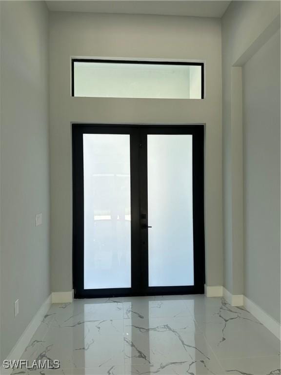 178 Mcarthur Blvd, Lehigh Acres, FL 33974 - entryway with marble tiled flooring and baseboards
