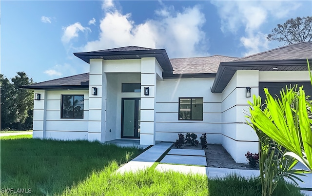 178 Mcarthur Blvd, Lehigh Acres, FL 33974 - view of front of property featuring roof with shingles and stucco siding