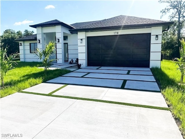 178 Mcarthur Blvd, Lehigh Acres, FL 33974 - view of front facade with driveway, stucco siding, an attached garage, a front lawn, and a shingled roof