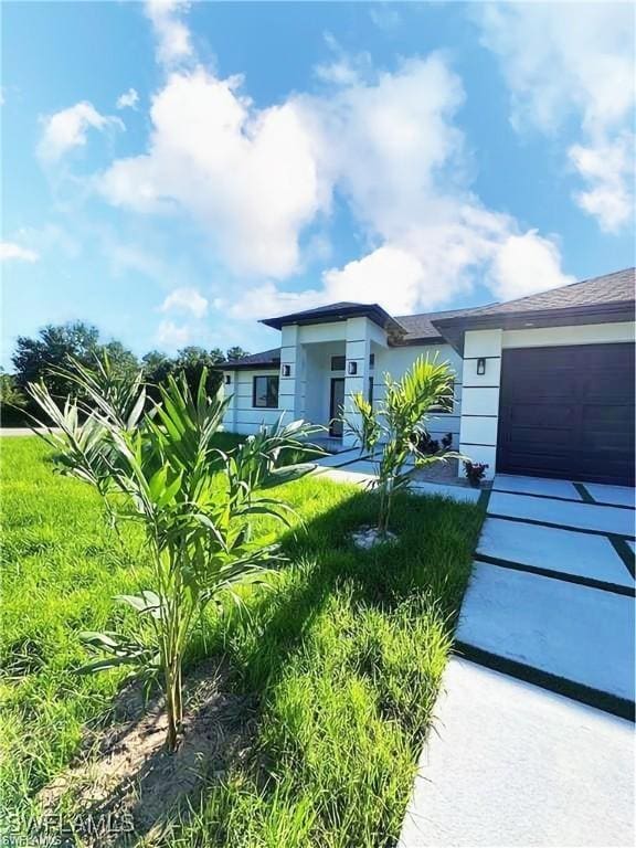 178 Mcarthur Blvd, Lehigh Acres, FL 33974 - view of front of property featuring an attached garage and stucco siding